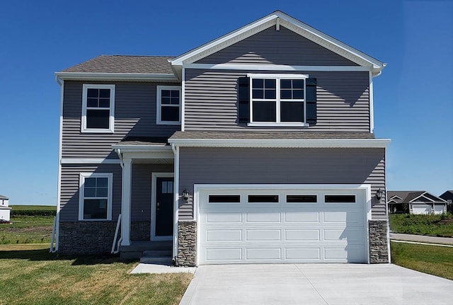 view of front of property featuring a garage and a front yard