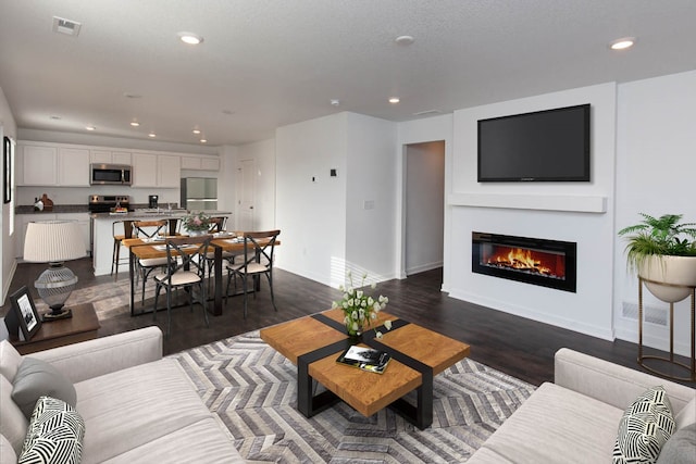 living room featuring dark wood-type flooring