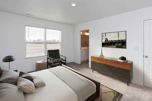 bedroom with carpet floors and ensuite bathroom