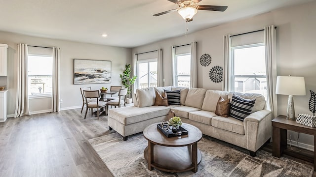 living area featuring recessed lighting, wood finished floors, baseboards, and ceiling fan