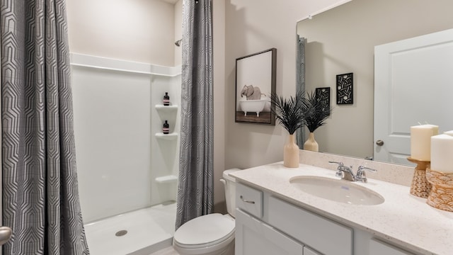 bathroom with vanity, toilet, and walk in shower