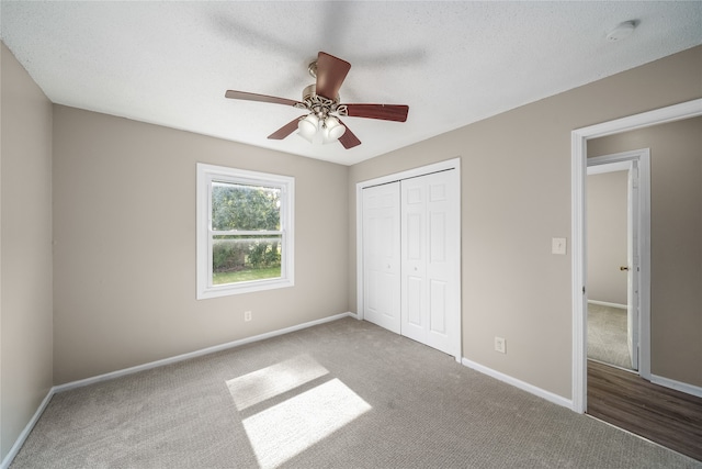 unfurnished bedroom featuring carpet floors, ceiling fan, and a closet