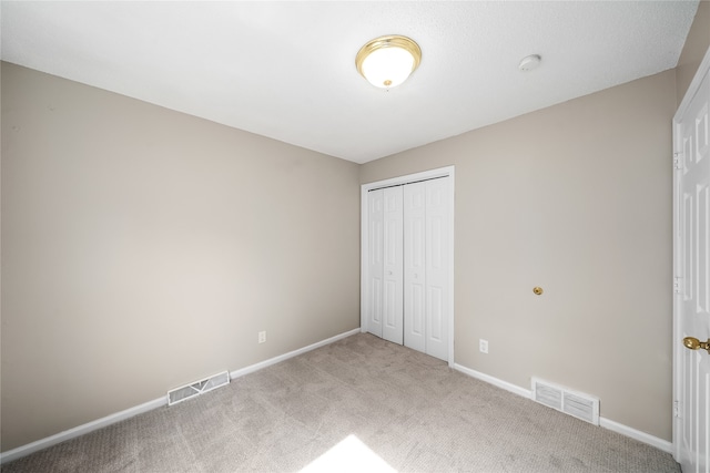 unfurnished bedroom with carpet floors and a closet