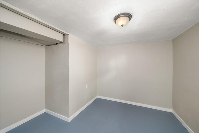 interior space featuring baseboards and concrete floors