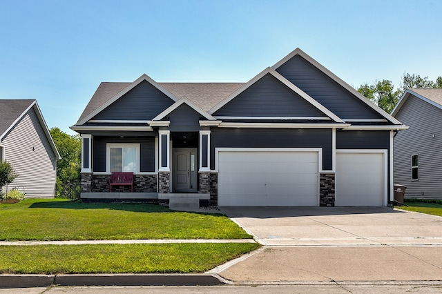 craftsman-style house featuring a front lawn and a garage