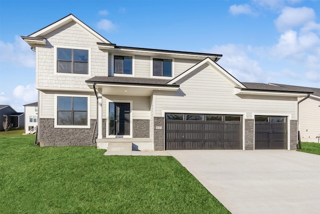 view of front of property featuring a garage and a front lawn