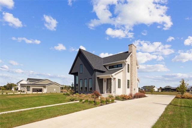 view of front of house with a front lawn and a garage