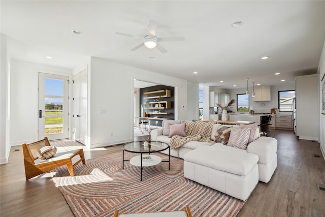 living room featuring ceiling fan and light hardwood / wood-style flooring