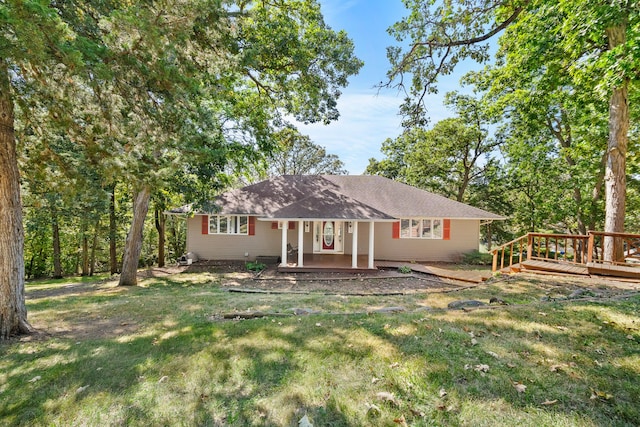 ranch-style house with a front yard and a deck