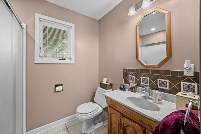 bathroom featuring vanity, tasteful backsplash, a textured ceiling, tile patterned floors, and toilet