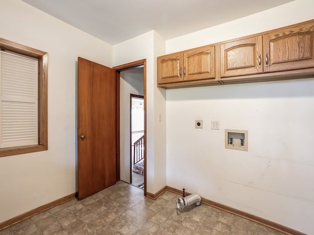 clothes washing area featuring cabinets, hookup for an electric dryer, and washer hookup