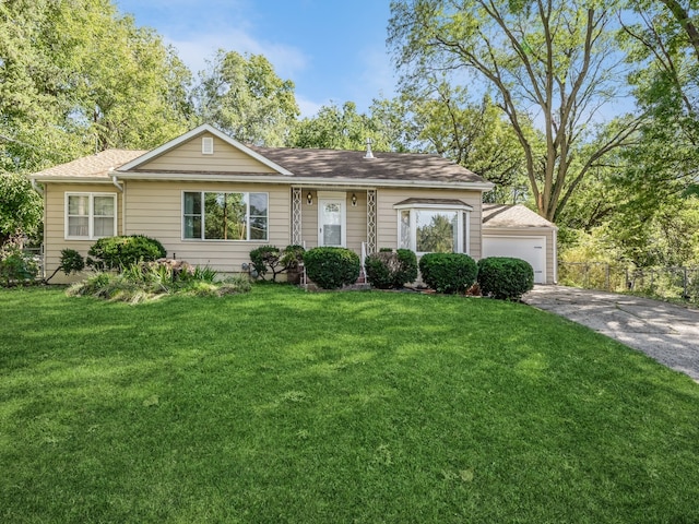 ranch-style house featuring a garage and a front lawn