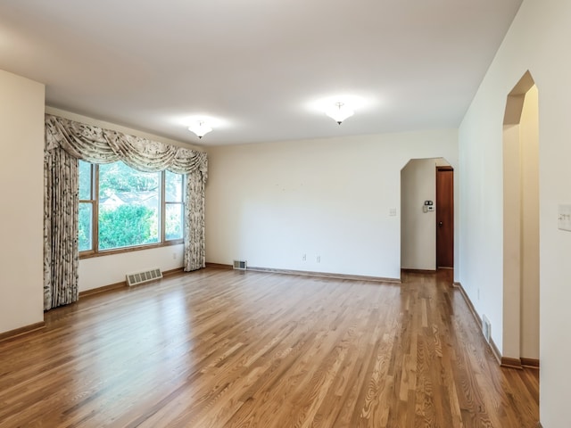 empty room with hardwood / wood-style floors