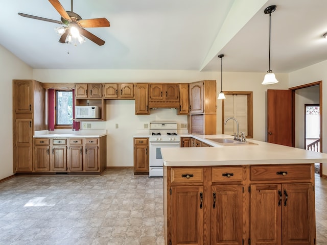 kitchen featuring ceiling fan, pendant lighting, sink, white appliances, and custom range hood