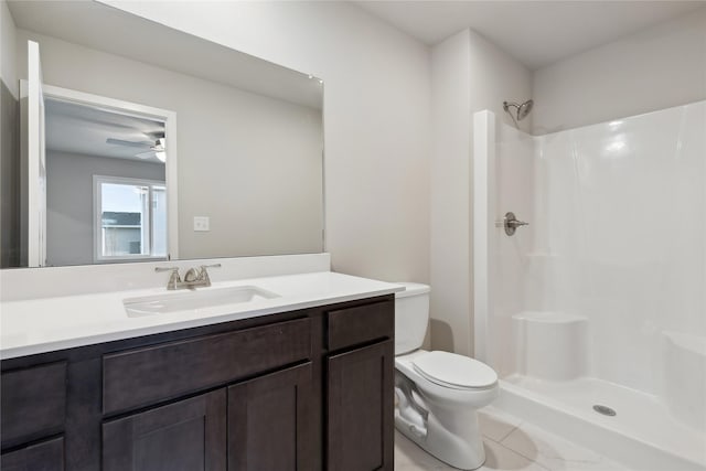 bathroom featuring vanity, tile patterned floors, toilet, and walk in shower