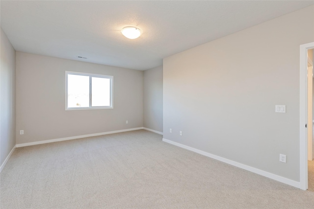 empty room featuring light carpet