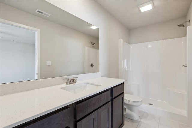 bathroom with toilet, vanity, and a shower