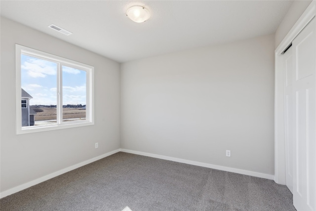 unfurnished bedroom with carpet and a closet