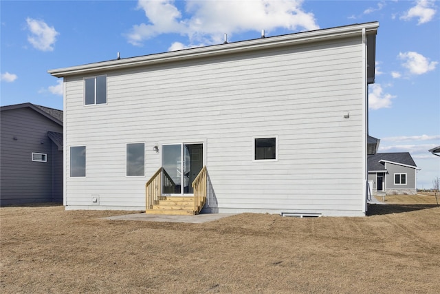 rear view of house featuring a yard