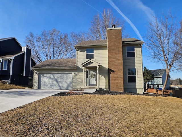 traditional home with concrete driveway, an attached garage, a front yard, and a chimney