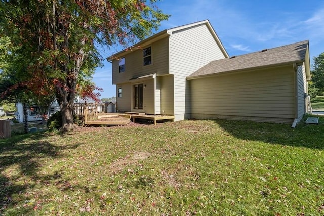 back of house with a lawn and a wooden deck