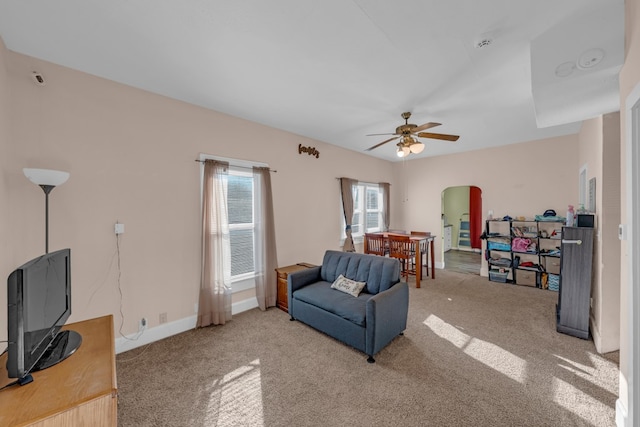 living room featuring carpet and ceiling fan