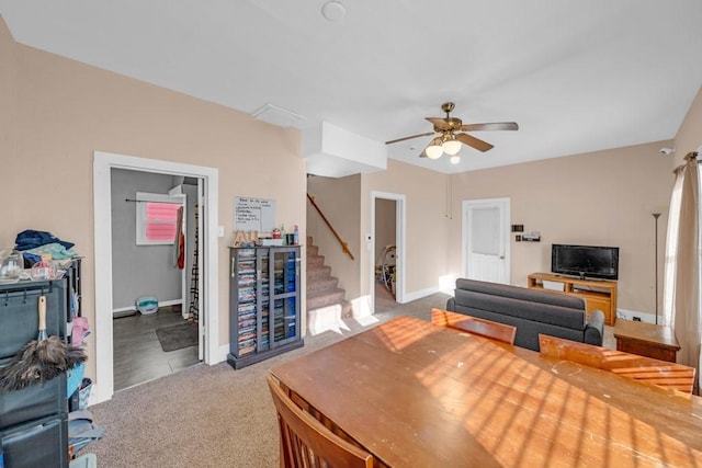 2329 Maple St, Des Moines, IA 50317 - living area featuring stairway, carpet, a ceiling fan, and baseboards