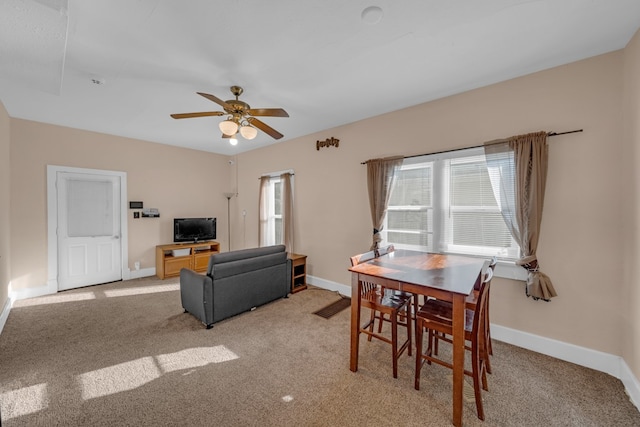 dining room featuring light carpet and ceiling fan