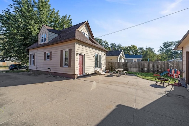 2329 Maple St, Des Moines, IA 50317 - view of property exterior with entry steps, fence, and a patio
