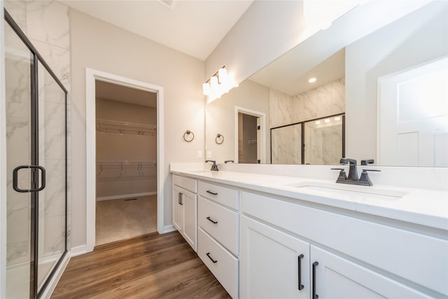 bathroom featuring vanity, a shower with shower door, and hardwood / wood-style flooring