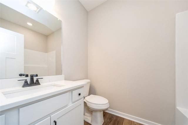 bathroom featuring vanity, toilet, and hardwood / wood-style floors