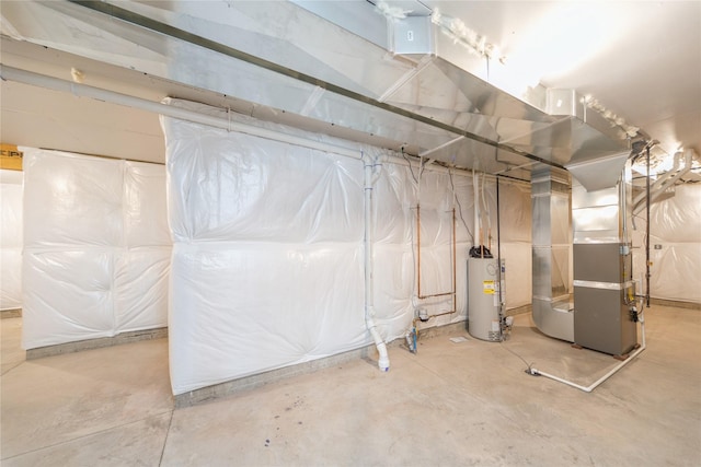 basement featuring gas water heater and heating unit