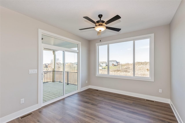 spare room featuring ceiling fan and dark hardwood / wood-style flooring