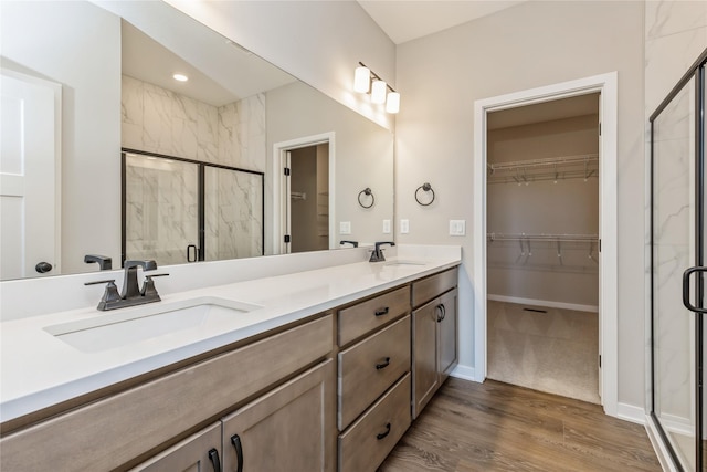 bathroom featuring vanity, hardwood / wood-style flooring, and an enclosed shower