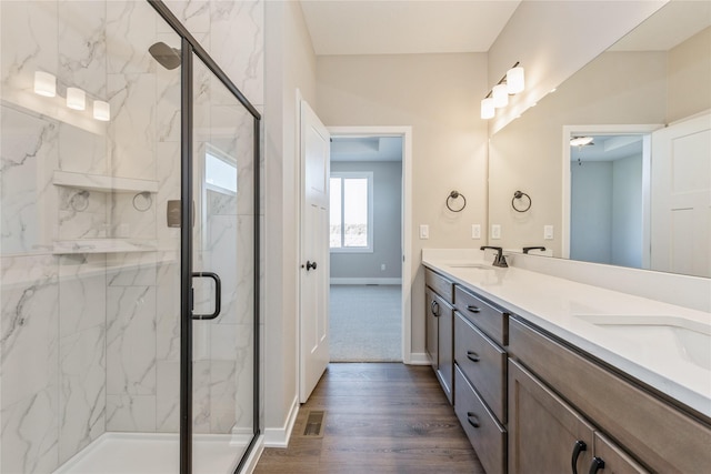 bathroom featuring ceiling fan, a shower with door, vanity, and wood-type flooring