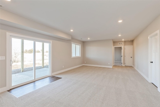 empty room with light colored carpet and plenty of natural light