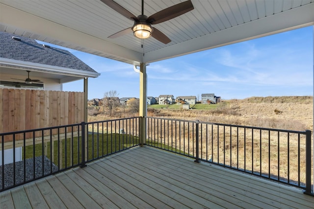 deck with ceiling fan and a yard