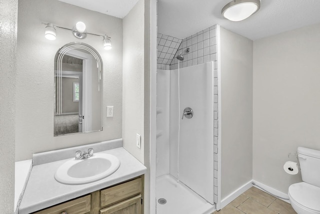 full bath with baseboards, toilet, tile patterned floors, vanity, and a shower stall