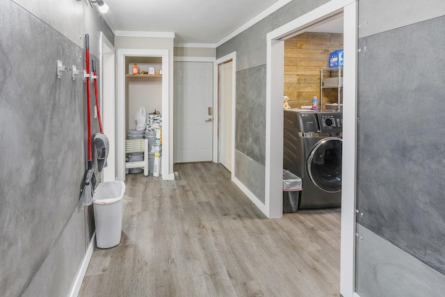 interior space with washer / dryer, ornamental molding, and wood finished floors