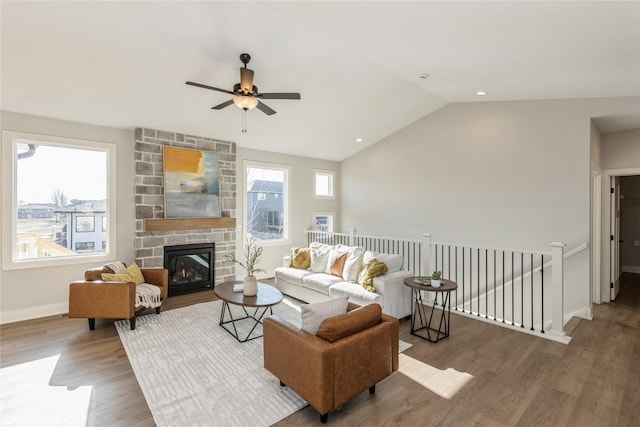 living room featuring ceiling fan, lofted ceiling, a fireplace, and hardwood / wood-style floors