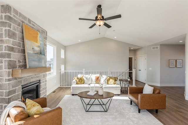 living room with hardwood / wood-style flooring, lofted ceiling, a fireplace, and ceiling fan