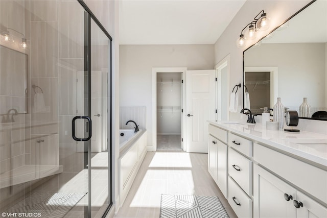 bathroom featuring tile patterned flooring, vanity, and separate shower and tub