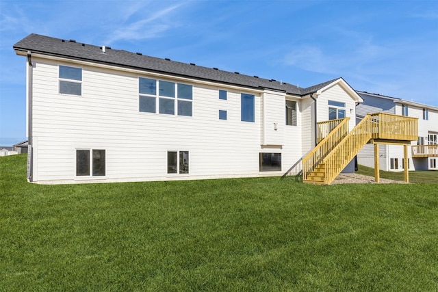 rear view of property featuring a deck and a lawn