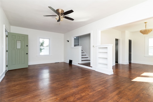 unfurnished living room featuring ceiling fan and dark wood-type flooring