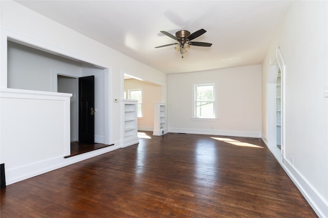 unfurnished living room with dark hardwood / wood-style floors and ceiling fan