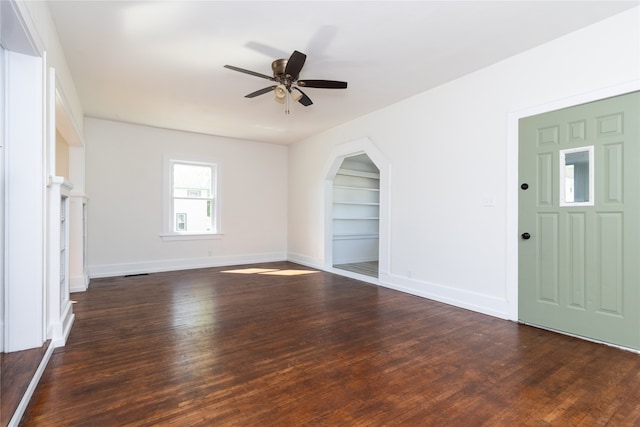 interior space with ceiling fan and dark wood-type flooring