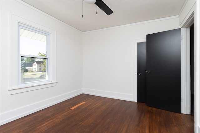 unfurnished room featuring crown molding, ceiling fan, and dark wood-type flooring