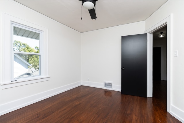 spare room with dark hardwood / wood-style flooring and ceiling fan