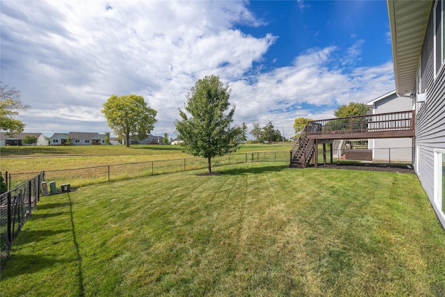 view of yard featuring a fenced backyard, stairway, and a deck