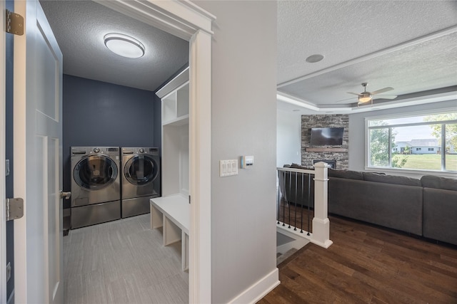 laundry room featuring washer and dryer, ceiling fan, a textured ceiling, and laundry area